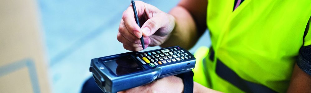 Male warehouse worker with barcode scanner.