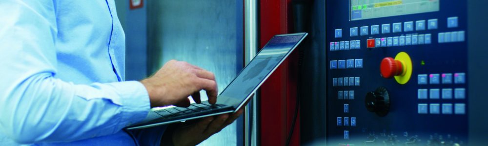 Chief Engineer/ Operator Programs/ Sets-up CNC Machine with Control Panel. He Works on the Modern Technologically Advanced Factory.